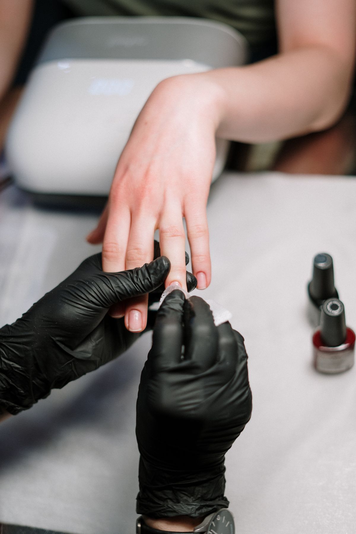 Nail technician applying gel polish at Eastside Nails